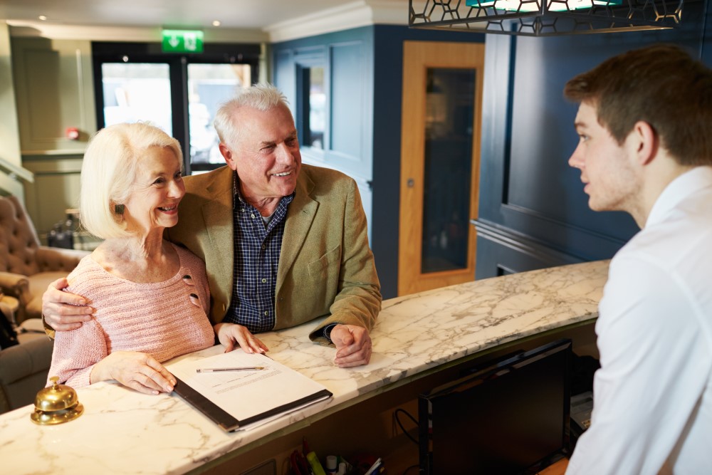 elder-couple-checking-into-hotel